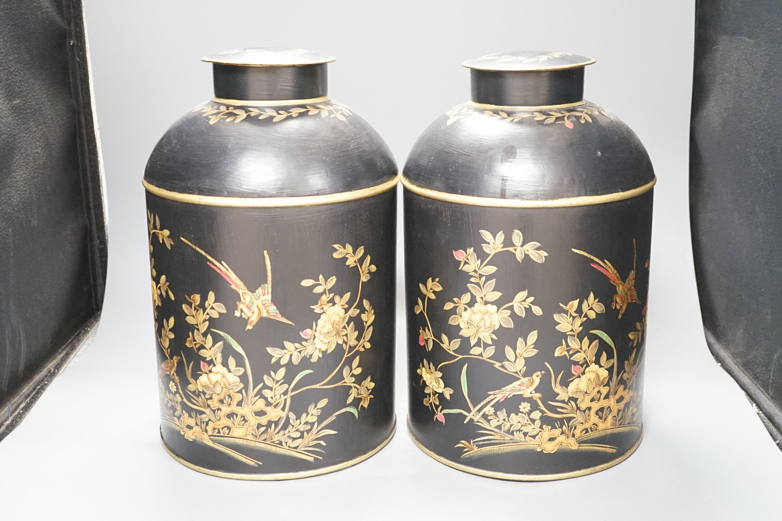 A pair of toleware style tea cannisters, 36 cms high.